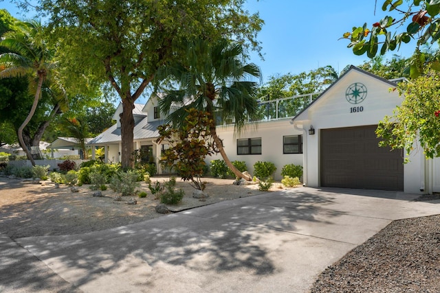 1610 Von Phister St, Key West, FL 33040 - view of front of property with a garage, driveway, and stucco siding