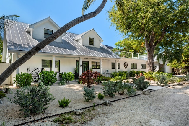 1610 Von Phister St, Key West, FL 33040 - view of front facade featuring stucco siding, metal roof, and covered porch