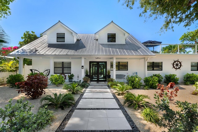 1610 Von Phister St, Key West, FL 33040 - modern farmhouse style home with french doors, covered porch, stucco siding, metal roof, and a standing seam roof