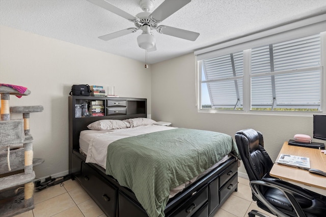 3635 Seaside Dr Unit 314, Key West, FL 33040 - bedroom with baseboards, light tile patterned floors, a textured ceiling, and a ceiling fan