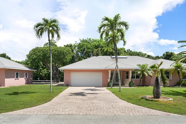 single story home featuring a garage and a front yard