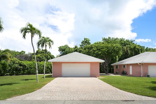 single story home with central AC and a front yard