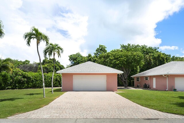 single story home with central AC and a front yard