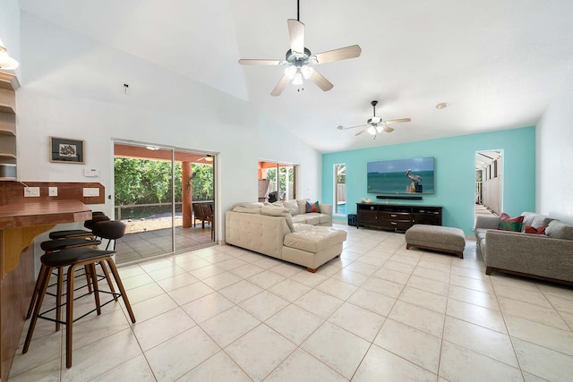 tiled living room featuring ceiling fan and high vaulted ceiling