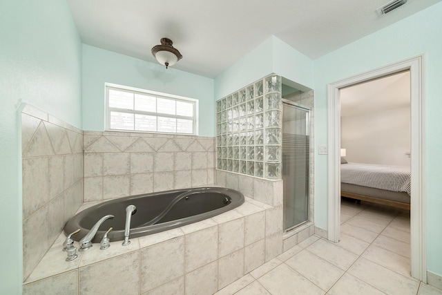 bathroom with independent shower and bath and tile patterned floors