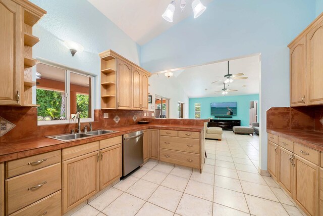 kitchen with sink, light brown cabinets, stainless steel dishwasher, kitchen peninsula, and decorative backsplash