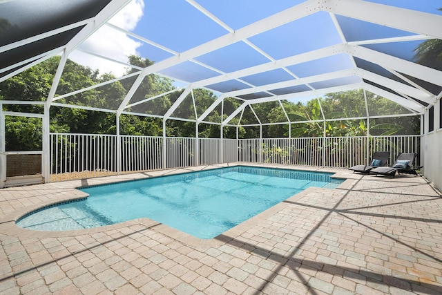 view of swimming pool with a lanai and a patio area