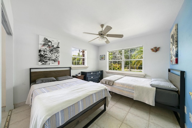 tiled bedroom featuring ceiling fan