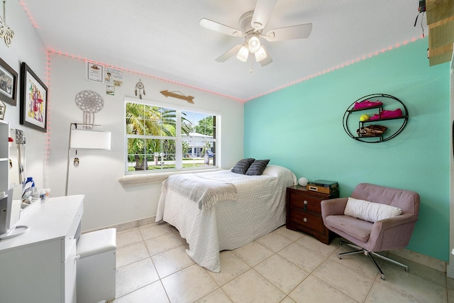 bedroom with ceiling fan and light tile patterned floors