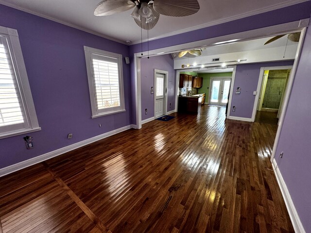 318 Margaret St, Key West, FL 33040 - unfurnished living room with a ceiling fan, dark wood-style flooring, baseboards, and crown molding