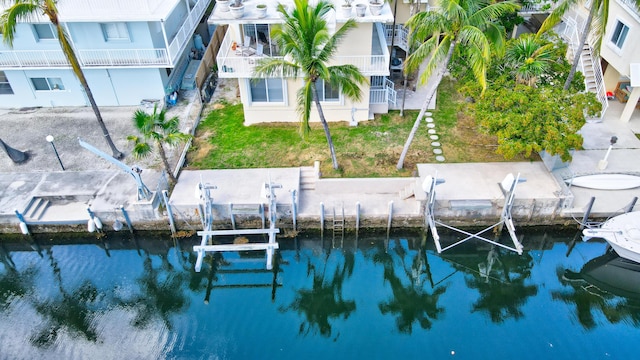 dock area featuring a water view and a yard