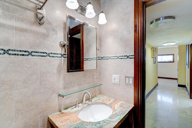 bathroom with vanity and tile walls