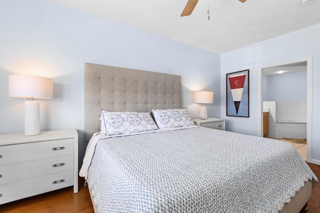 bedroom featuring ceiling fan, ensuite bathroom, and hardwood / wood-style floors