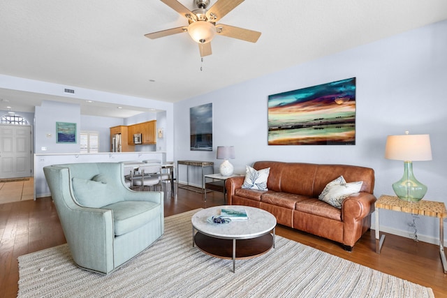 living room with light hardwood / wood-style floors and ceiling fan