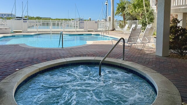 view of pool with a community hot tub