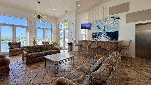 living room featuring ceiling fan and high vaulted ceiling