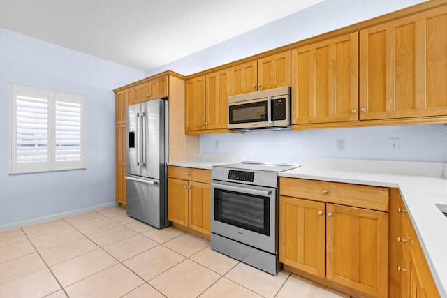 kitchen featuring light tile patterned floors and stainless steel appliances