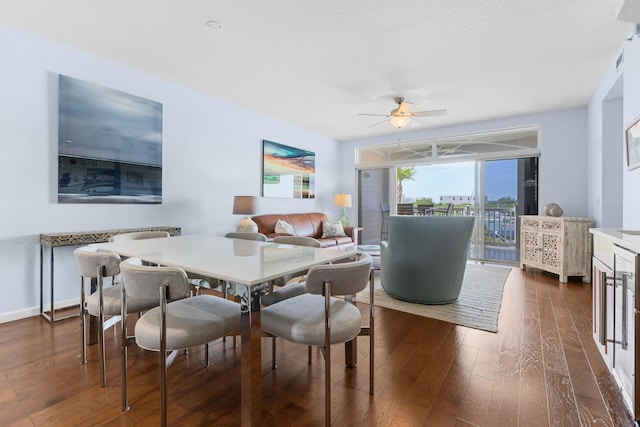 dining area featuring ceiling fan and dark hardwood / wood-style floors