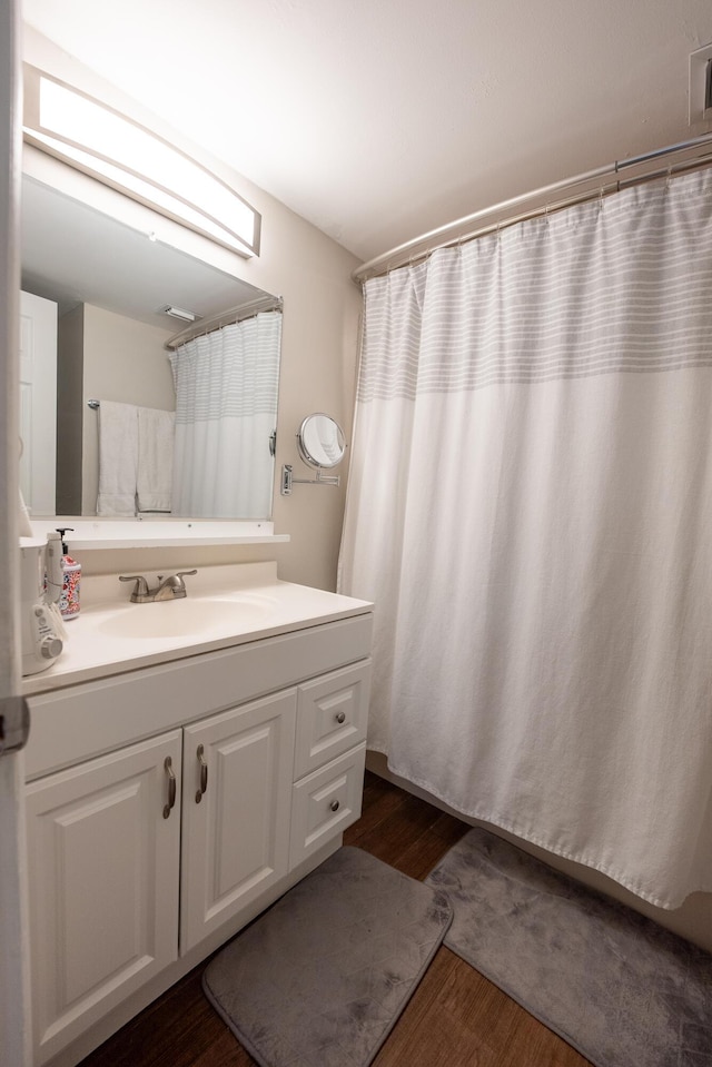 3314 Northside Dr Unit 31, Key West, FL 33040 - bathroom featuring wood finished floors, vanity, and curtained shower
