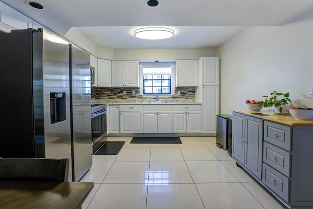 3314 Northside Dr Unit 31, Key West, FL 33040 - kitchen featuring stainless steel appliances, gray cabinets, white cabinets, and decorative backsplash