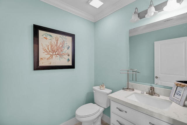 bathroom with ornamental molding, vanity, and toilet