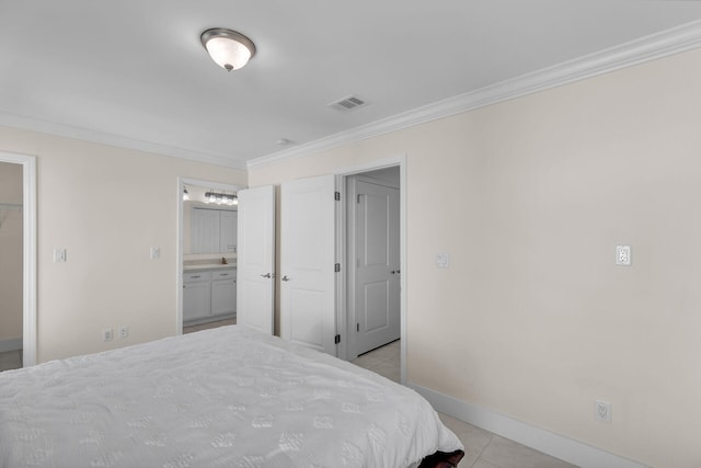 bedroom featuring crown molding, ensuite bath, and light tile patterned floors