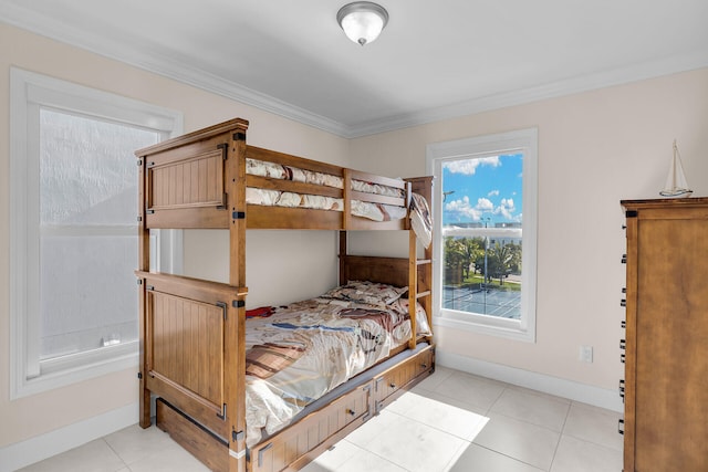 bedroom featuring crown molding and light tile patterned floors