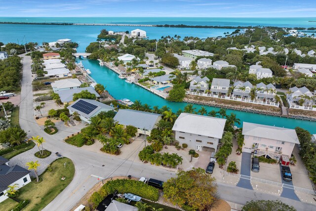 birds eye view of property with a water view and a residential view