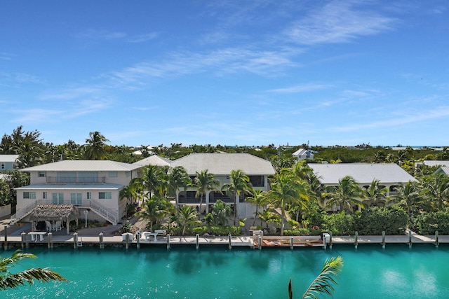 exterior space with a dock, a residential view, and stairway