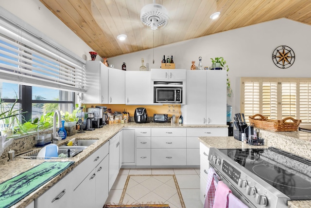 kitchen with light tile patterned floors, lofted ceiling, wood ceiling, appliances with stainless steel finishes, and a sink