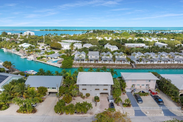 drone / aerial view with a water view and a residential view