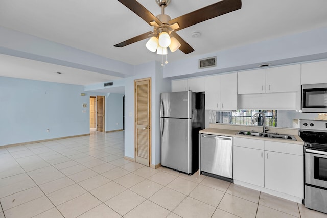 kitchen with light tile patterned floors, visible vents, appliances with stainless steel finishes, light countertops, and a sink