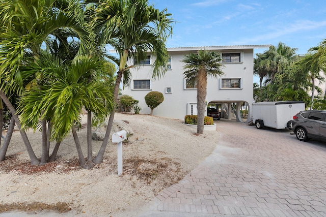 exterior space with a carport and decorative driveway