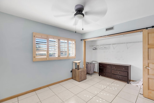 bedroom with light tile patterned floors, ceiling fan, visible vents, and baseboards