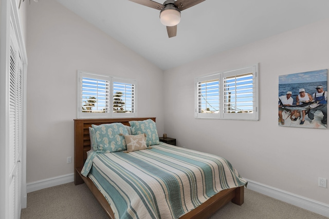 carpeted bedroom featuring multiple windows, lofted ceiling, and ceiling fan