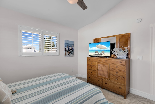 bedroom with vaulted ceiling, light colored carpet, and ceiling fan