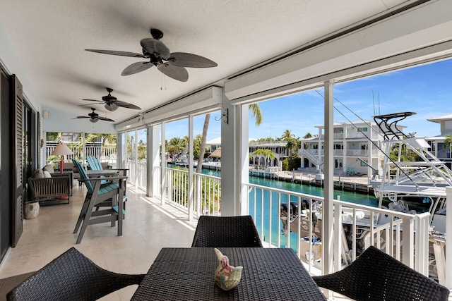 sunroom featuring a water view and a healthy amount of sunlight