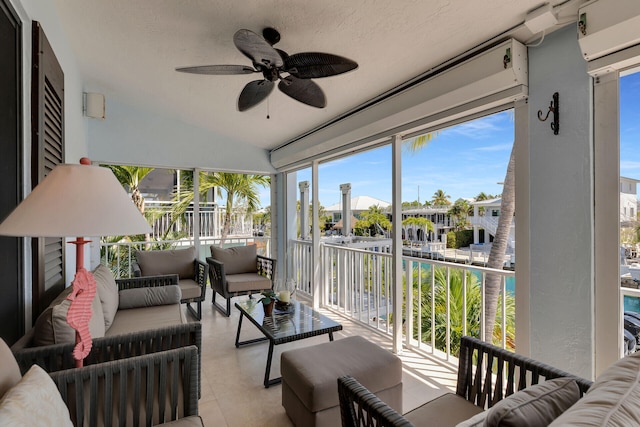 sunroom / solarium with ceiling fan and lofted ceiling