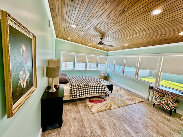 bedroom with crown molding, light hardwood / wood-style floors, and wooden ceiling