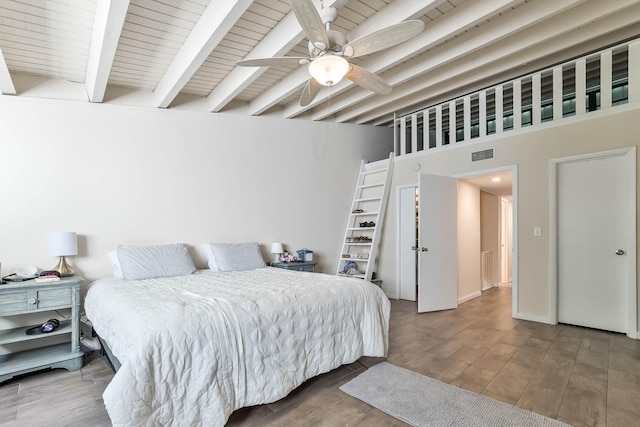 bedroom featuring beamed ceiling, ceiling fan, wood-type flooring, and wood ceiling