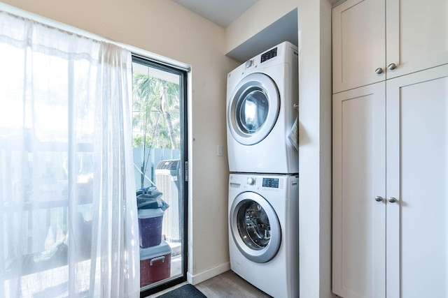 laundry area featuring stacked washer and clothes dryer