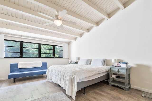 bedroom featuring ceiling fan, wood-type flooring, lofted ceiling with beams, and wooden ceiling