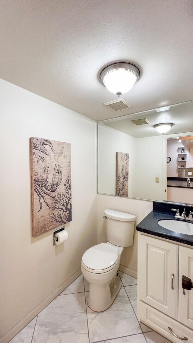 bathroom featuring vanity and toilet