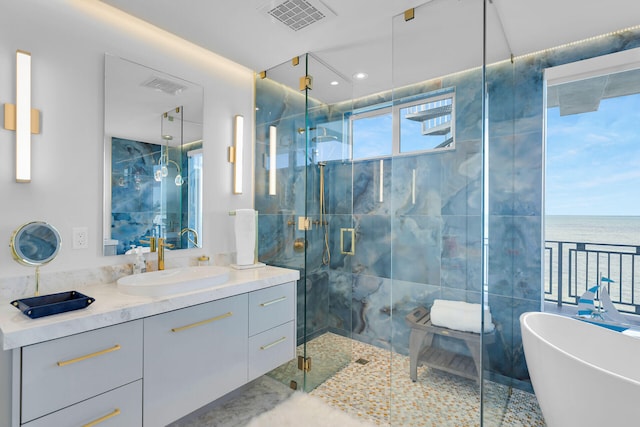 257 Normandy Dr, Tavernier, FL 33070 - full bathroom featuring a freestanding bath, vanity, a marble finish shower, and a water view