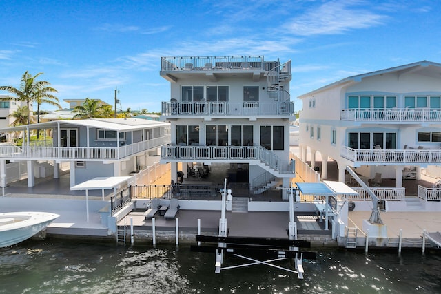 257 Normandy Dr, Tavernier, FL 33070 - back of property featuring a water view, a balcony, boat lift, and stairs