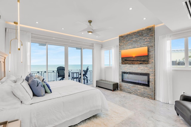 257 Normandy Dr, Tavernier, FL 33070 - bedroom with access to exterior, multiple windows, a stone fireplace, ceiling fan, and recessed lighting