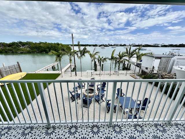 balcony with a water view and a dock