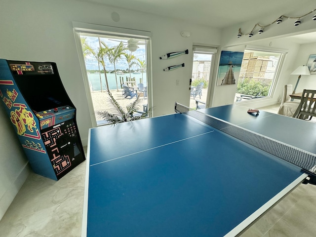 game room featuring a water view