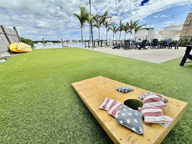 view of home's community with a lawn and a water view