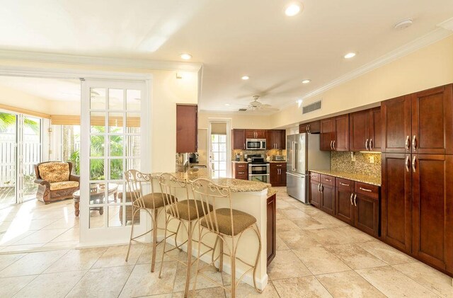 202 Admirals Ln, Key West, FL 33040 - kitchen with stainless steel appliances, ornamental molding, plenty of natural light, backsplash, and a breakfast bar area